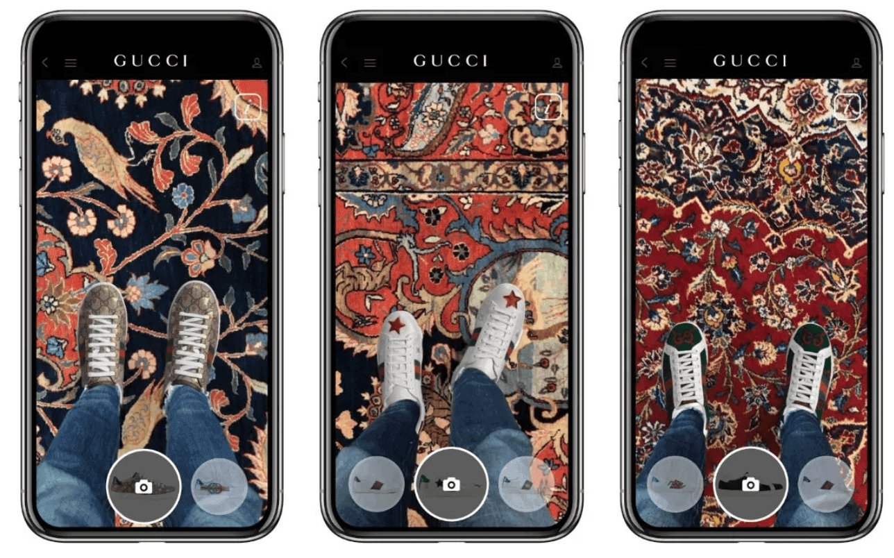 A smartphone screen showing a pair of digital Gucci sneakers overlaid on someone's real feet using AR.